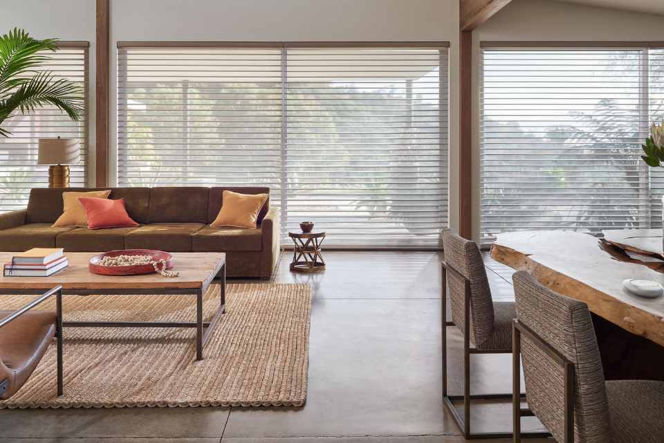 open concept living dining room with earth toned color palette and raw wood finishes